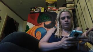 Hot blonde smokes clove cigarettes, plays on phone and plays with tits - 1 image