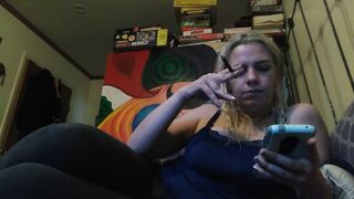 Hot blonde smokes clove cigarettes, plays on phone and plays with tits - 2 image
