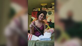 Tickles feet in tube socks with feather