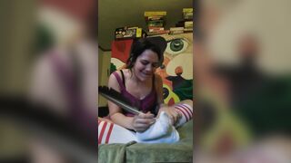 Tickles feet in tube socks with feather