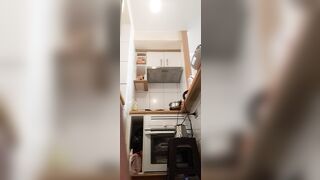 in the kitchen half-dressed