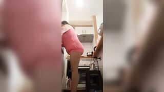 in the kitchen half-dressed