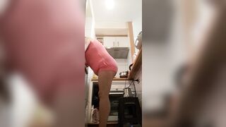 in the kitchen half-dressed