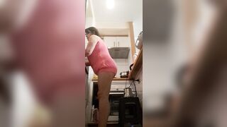 in the kitchen half-dressed