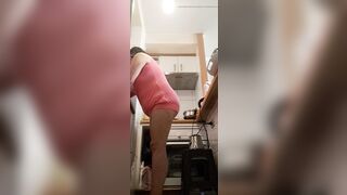 in the kitchen half-dressed