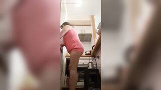 in the kitchen half-dressed