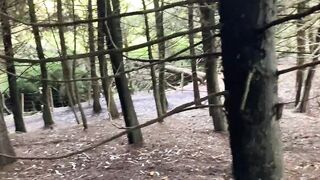 Gothic chick strokes a huge cock in the middle of the forest
