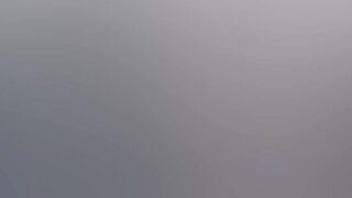 Gothic chick strokes a huge cock in the middle of the forest